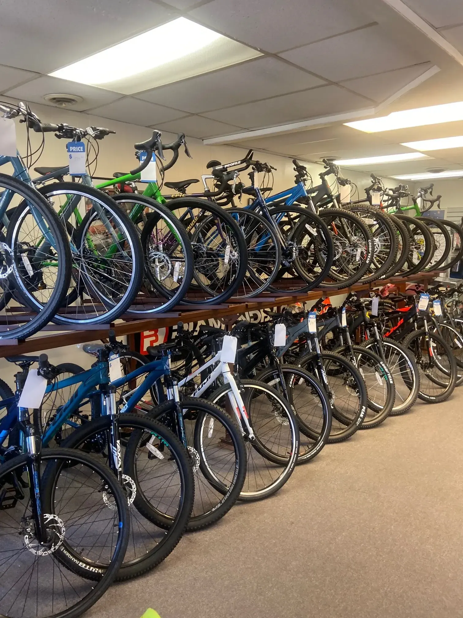 A row of new Diamondback and Fuji bicycles lined up on the showroom floor